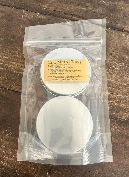 2 pack of 2oz metal tins packaged into a clear bag on a wooden surface