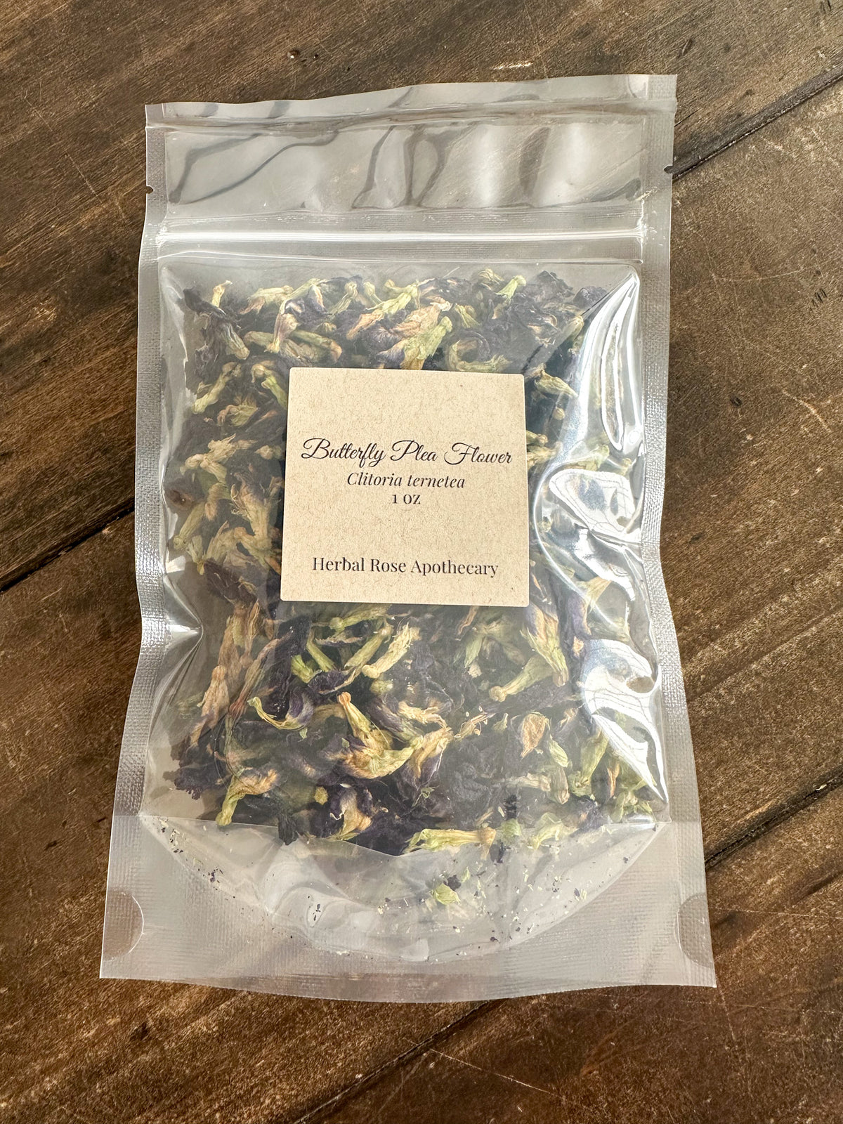 Packaged BUTTERFLY PEA FLOWER 1OZ with a label on a wooden surface