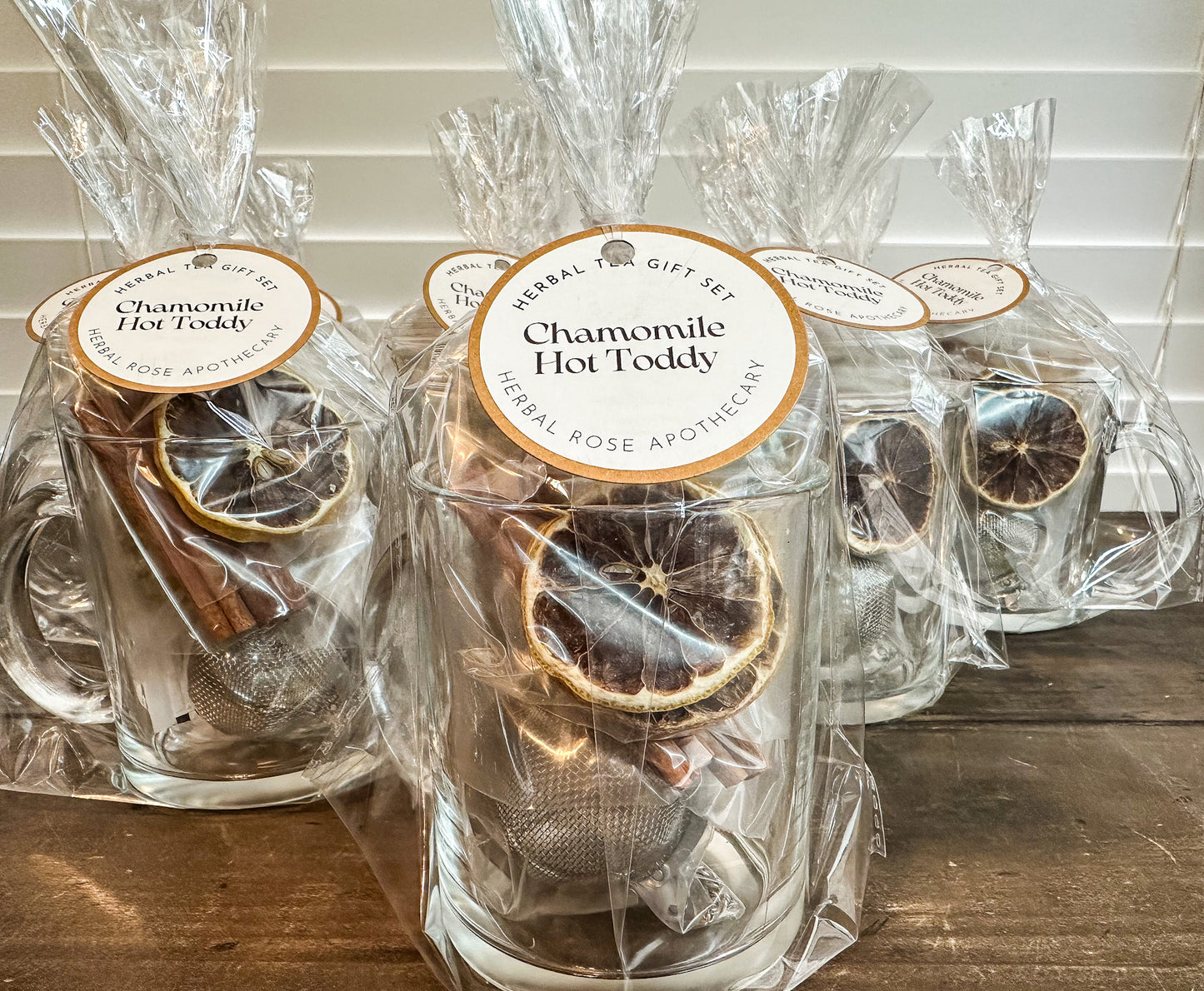 chamomile hot toddy set wrapped in cellophane with round tag  on wooden table