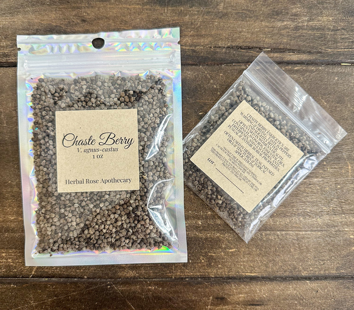 Two packages of Chaste Berry from Herbal Rose Apothecary on a wooden surface.