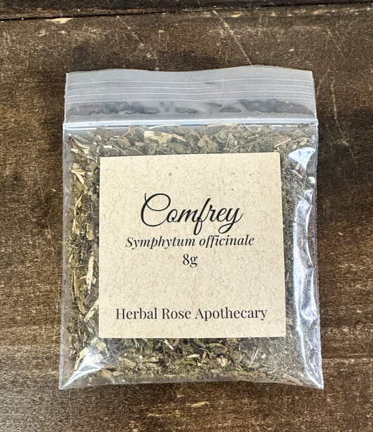 Comfrey 8g bag packaged from Herbal Rose Apothecary on a wooden surface