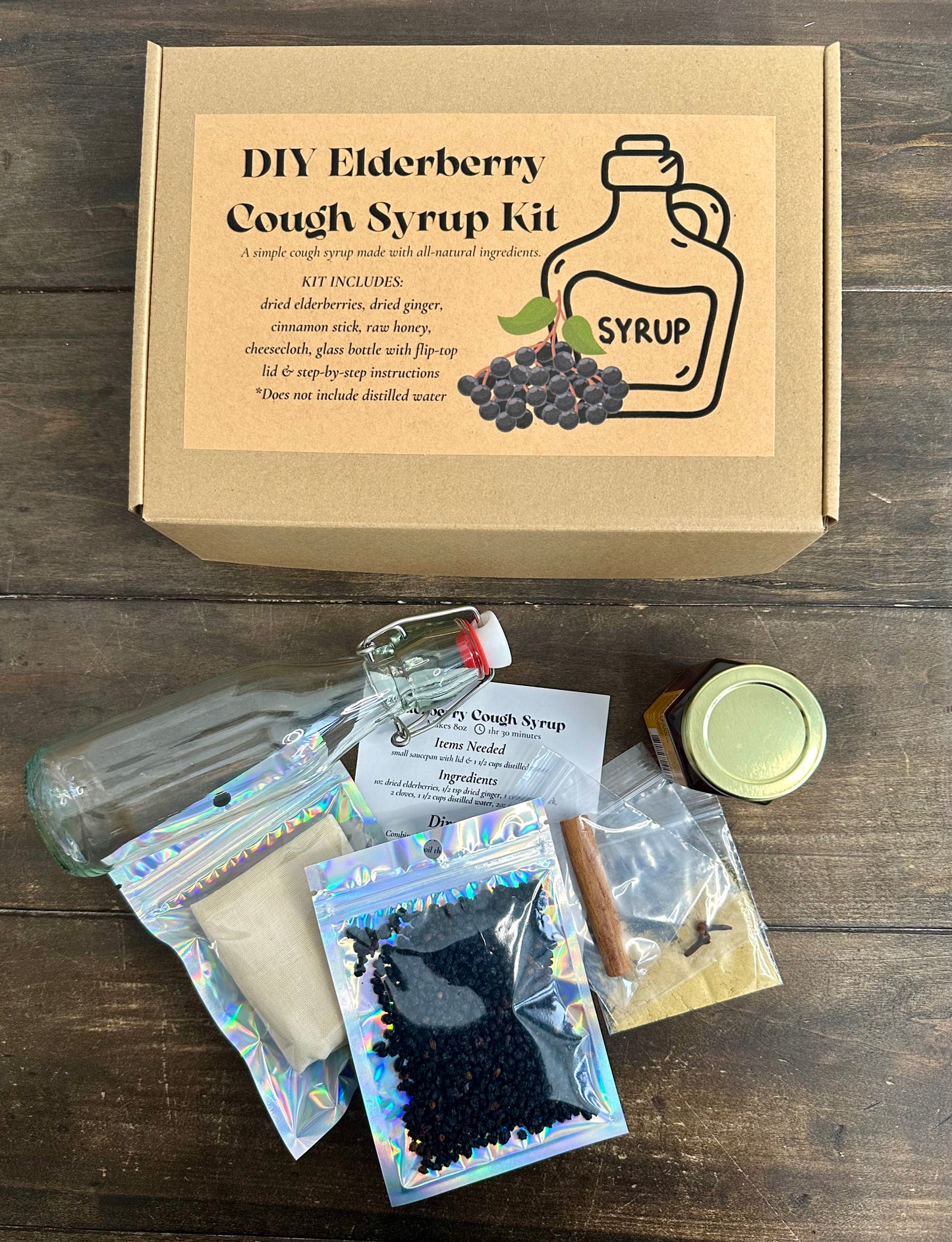 DIY Elderberry Cough Syrup kit with ingredients on a wooden surface