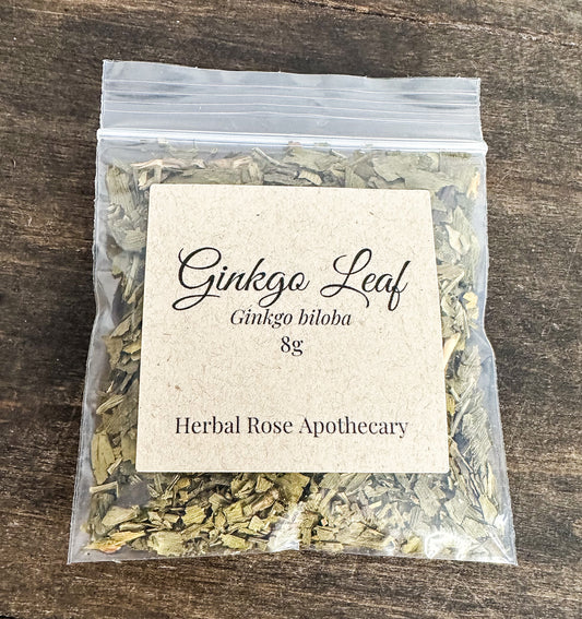 Packaged ginkgo leaf on a wooden surface with a label from Herbal Rose Apothecary.