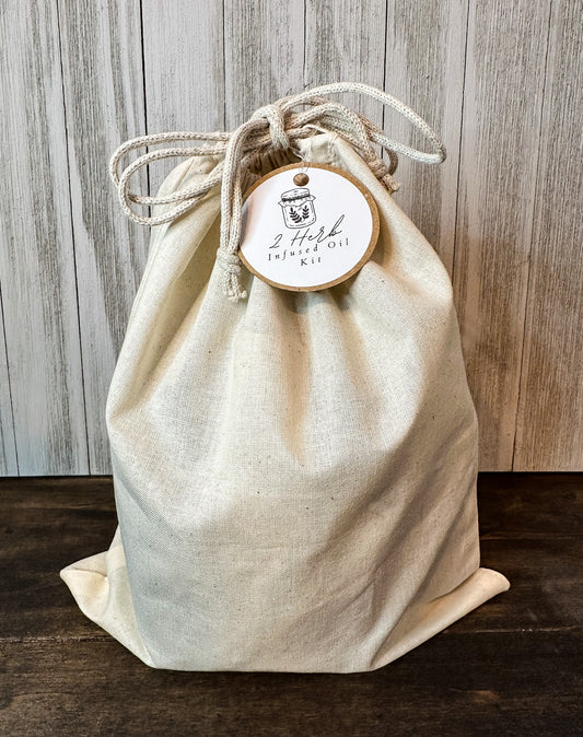 2 herb infused oil kit in canvas bag with brown and white hang tag with wooden background