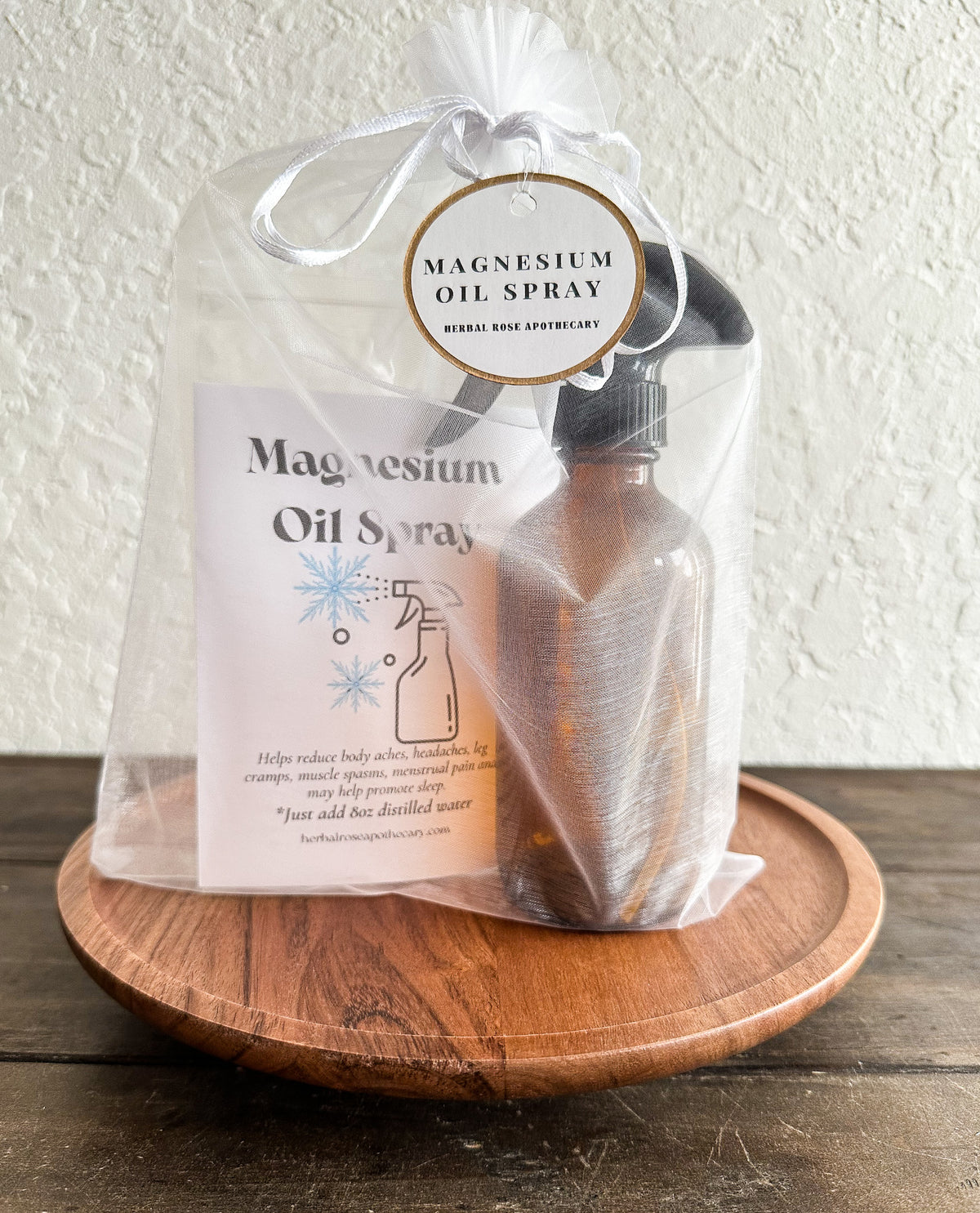 Magnesium oil spray bottle with packaging on a wooden surface