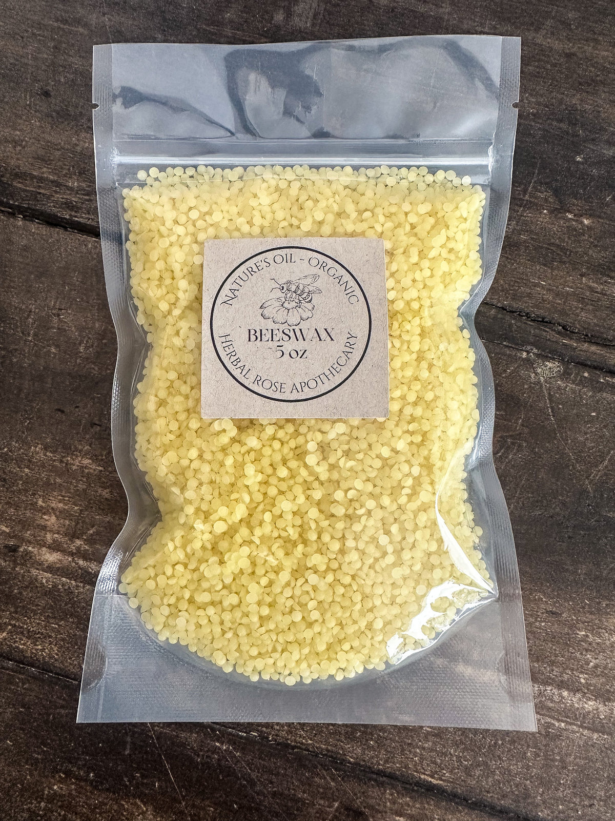 organic beeswax 5oz in clear resealable bag on wooden surface