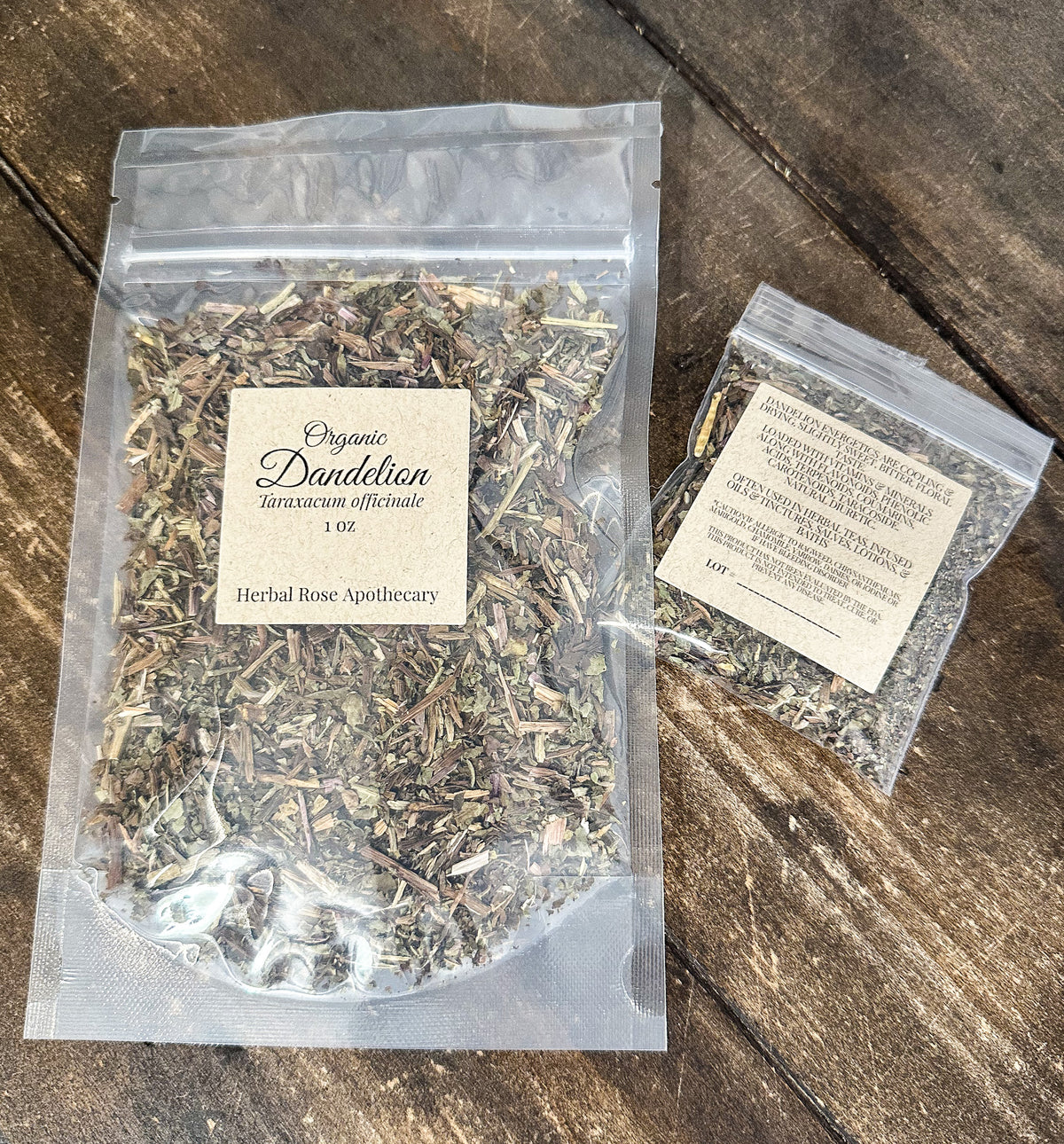 two packages of dried organic dandelion leaves in clear resealable bags from herbal rose apothecary on a wooden surface