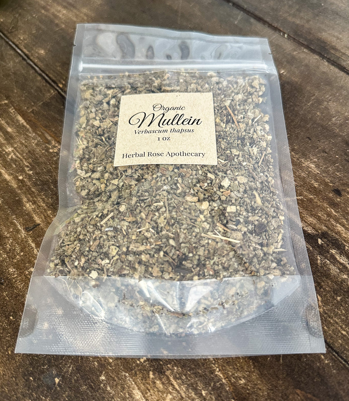 dried organic mullein leaves in a 1oz clear resealable bag on a wooden surface