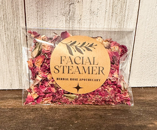 facial steamers rose, brown table with white wood background packaged in cellophane