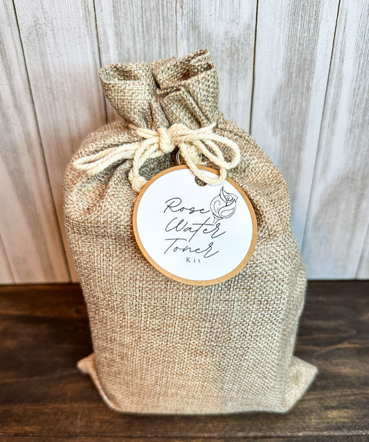 rose toner kit in canvas bag with brown and white round tag and gray and brown background