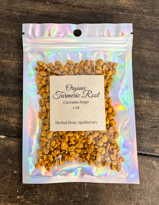 dried organic turmeric root in 1oz holographic bag on wooden surface