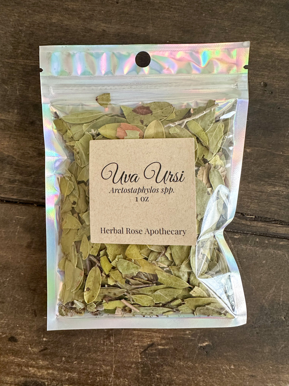 dried uva ursi leaves in 1oz holographic bag on wooden surface