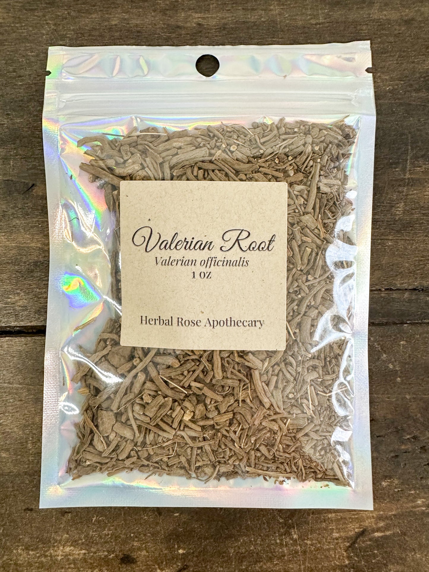 dried valerian root in 1oz holographic bag on wooden surface