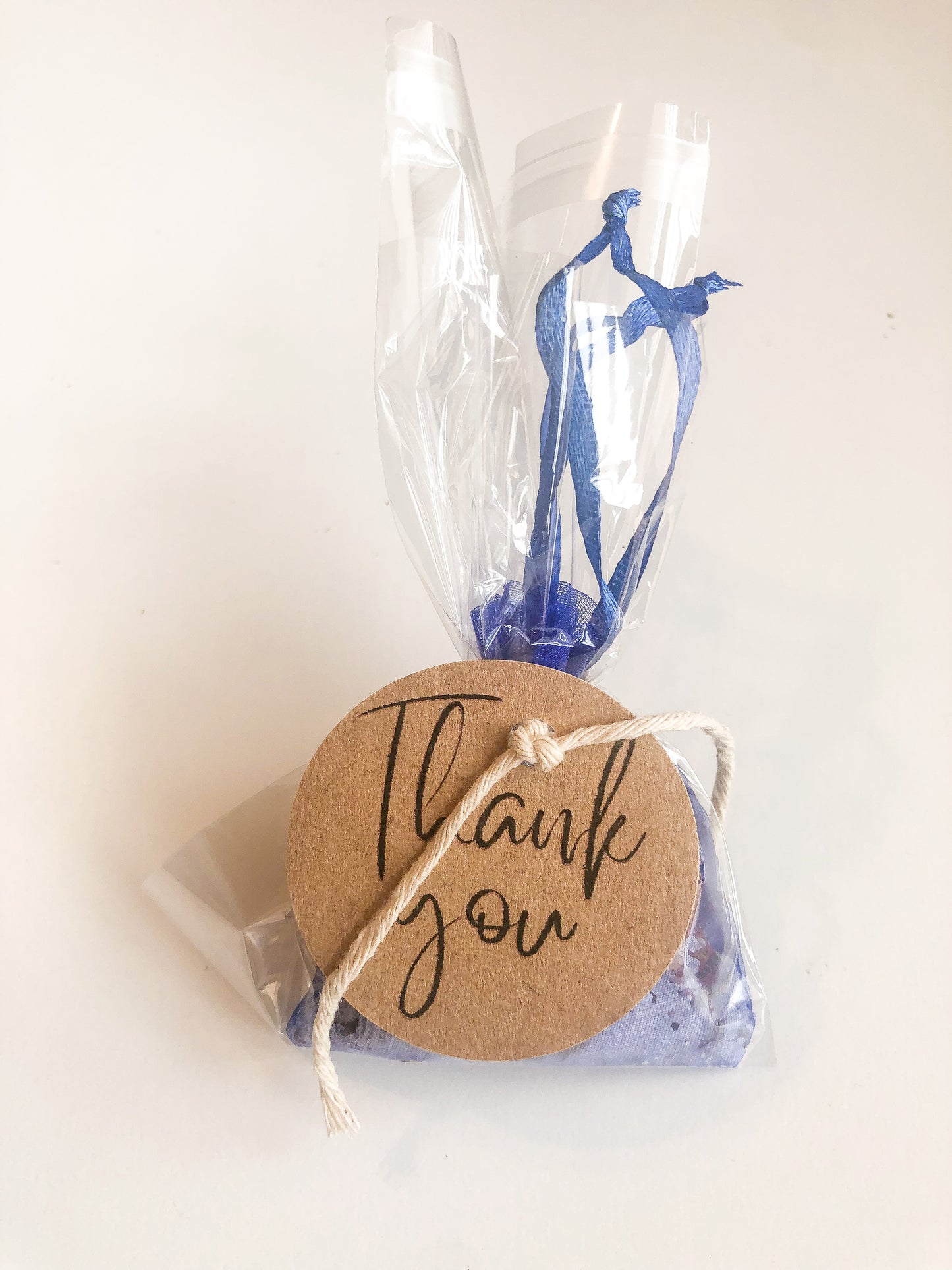 herbal tea bath with than you appreciation tag on wooden table with white wooden background
