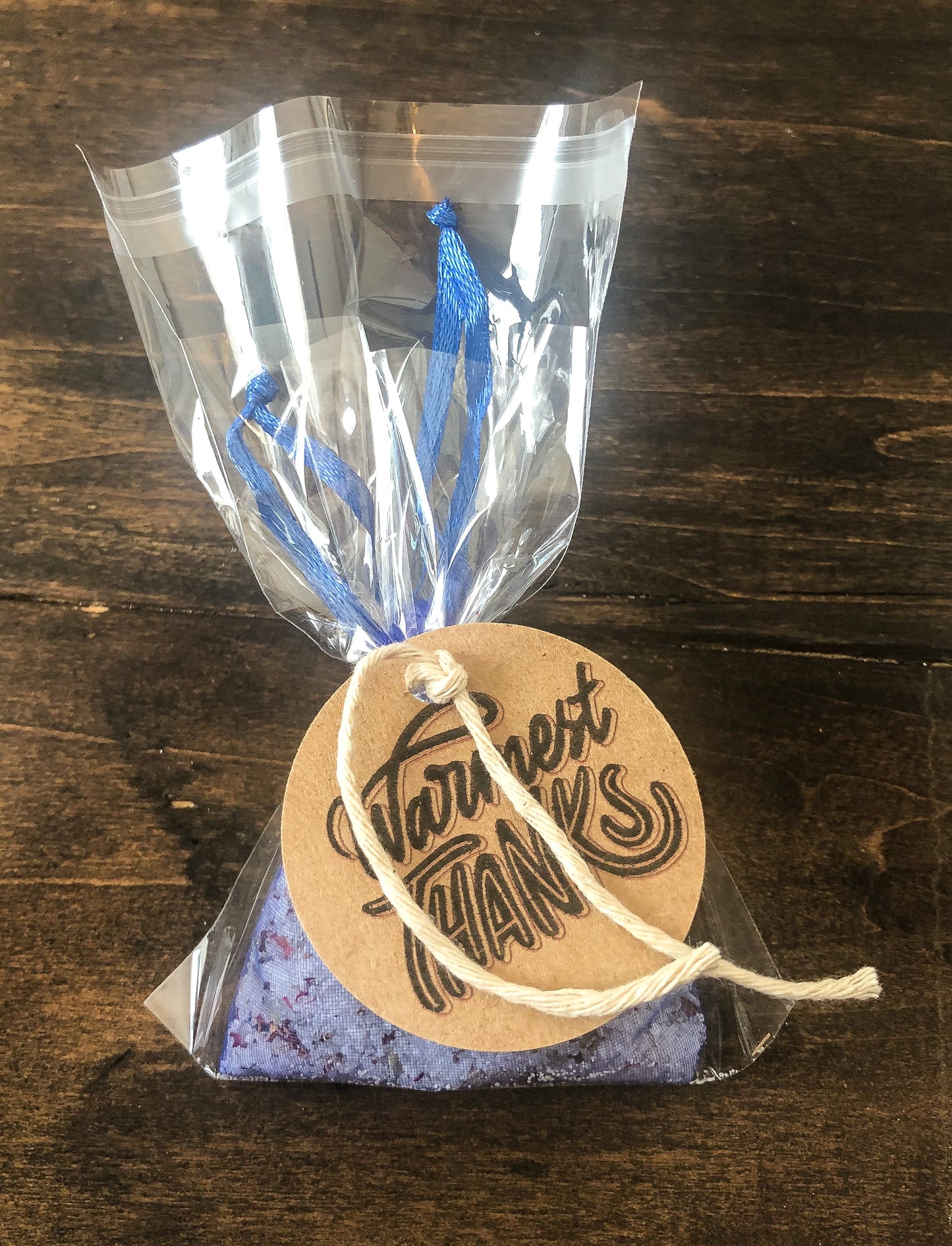 herbal tea bath with than you appreciation tag on wooden table with white wooden background