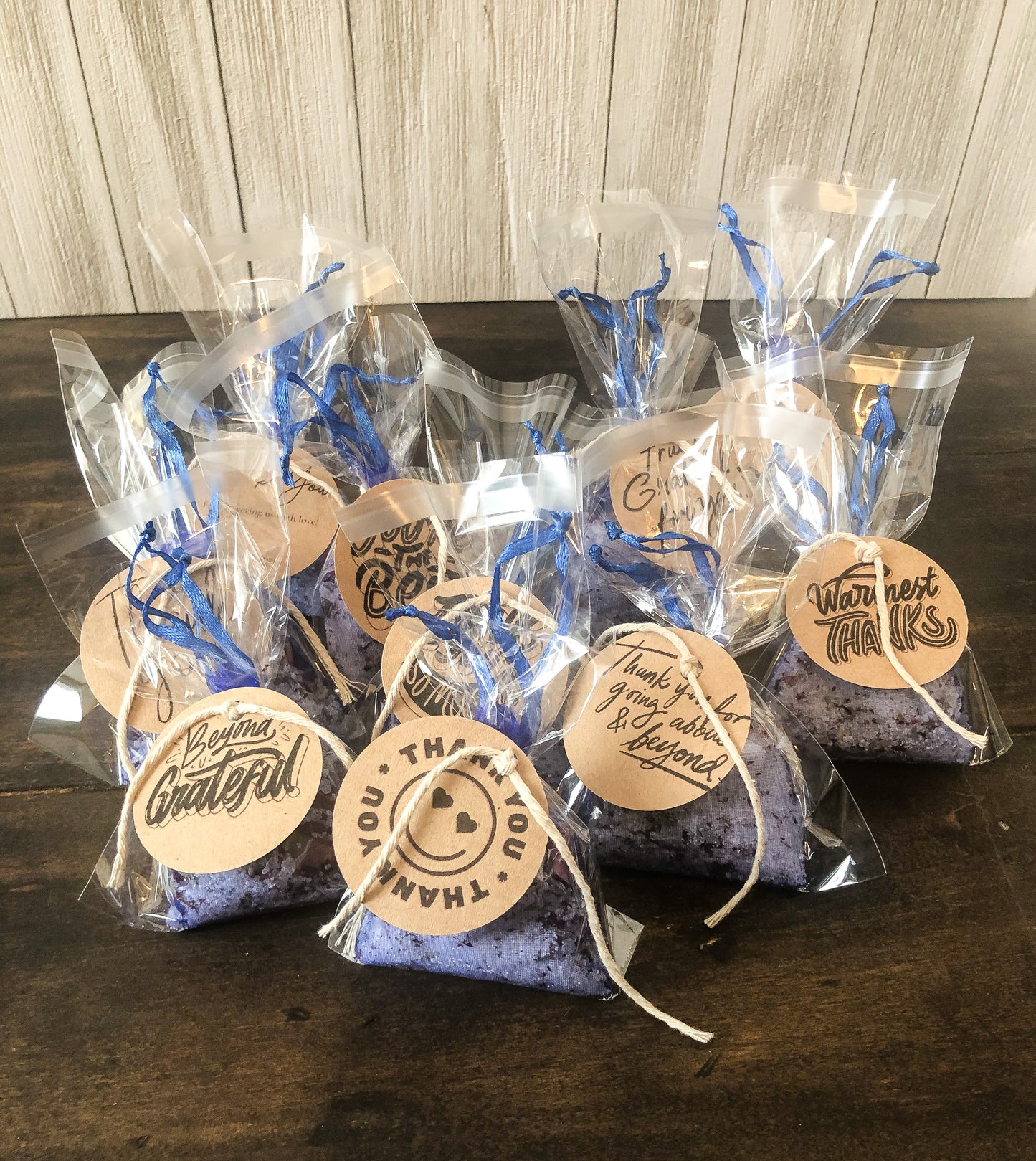 bulk herbal tea bath party favor/appreciation gifts on wooden table with white wooden background