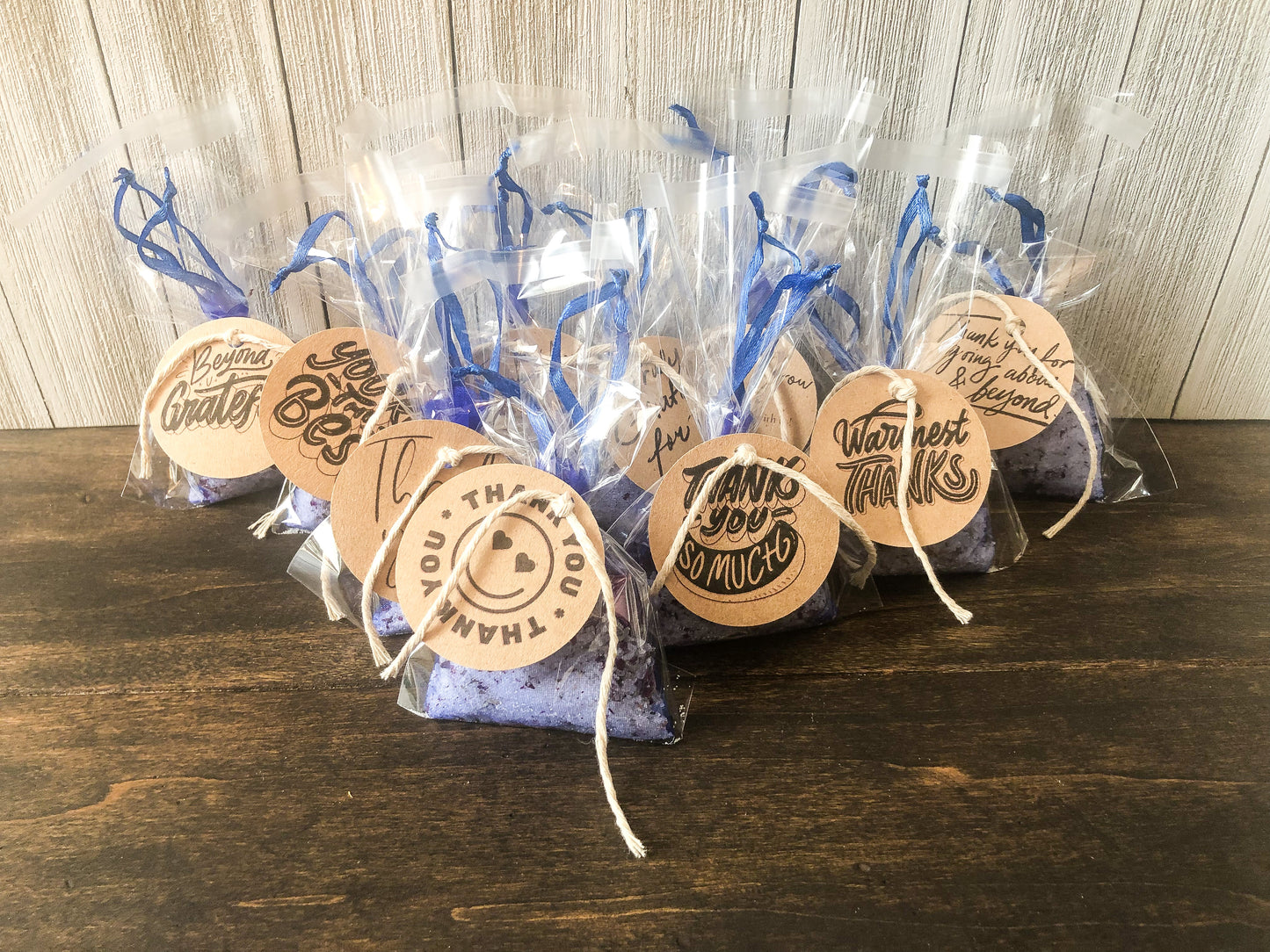 bulk herbal tea bath party favor/appreciation gifts on wooden table with white wooden background