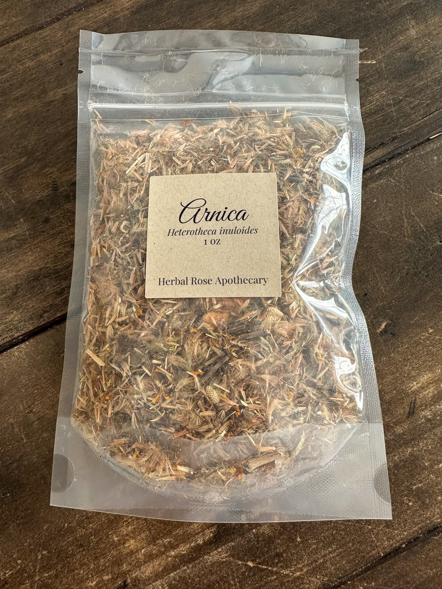 packaged with Arnica 1oz label on a wooden surface
