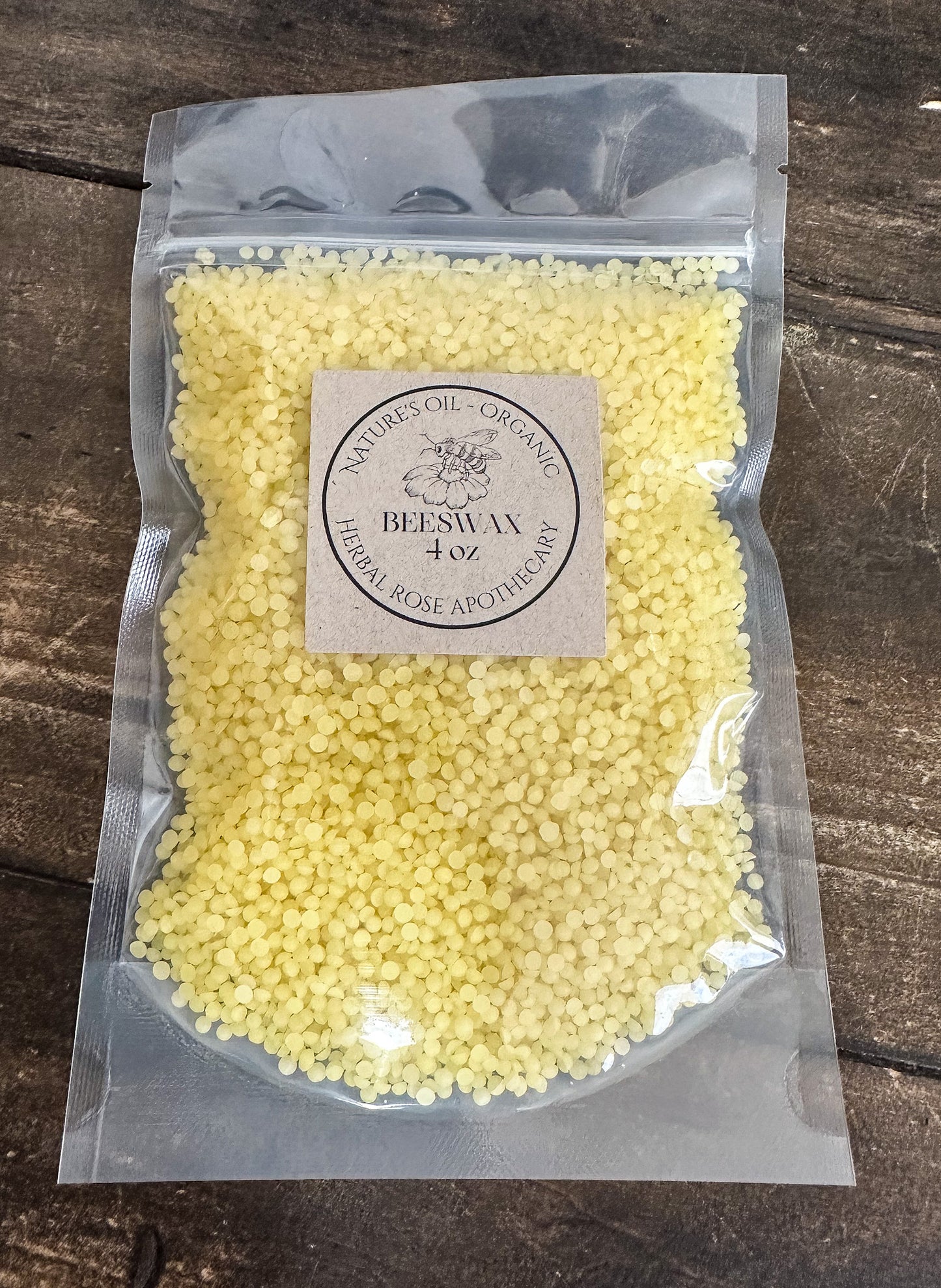 Packaged yellow beads with a label on a wooden surface