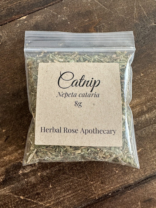 Package of catnip 8g from Herbal Rose Apothecary on a wooden surface