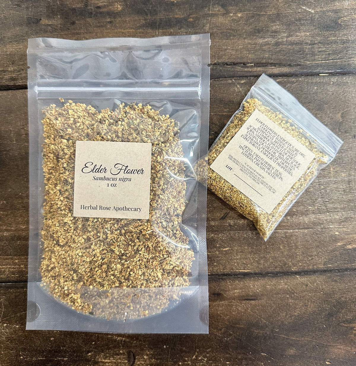 two packages of elder flowers on a wooden surface