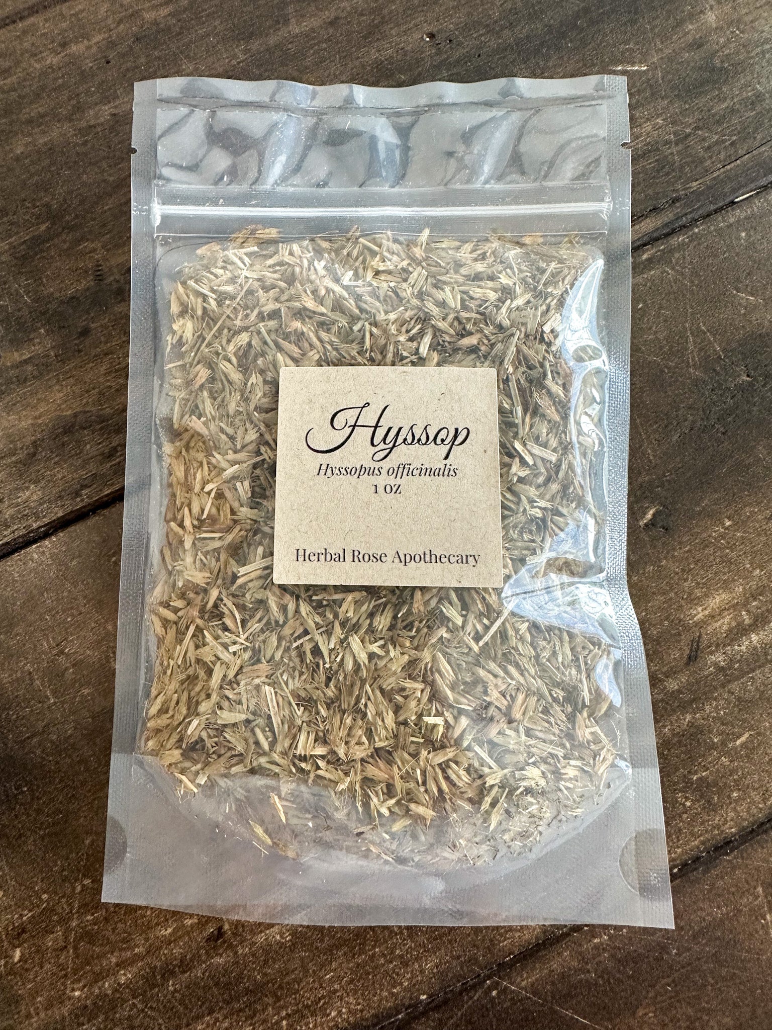 dried hysoop 1oz bag in clear packaging on wooden surface