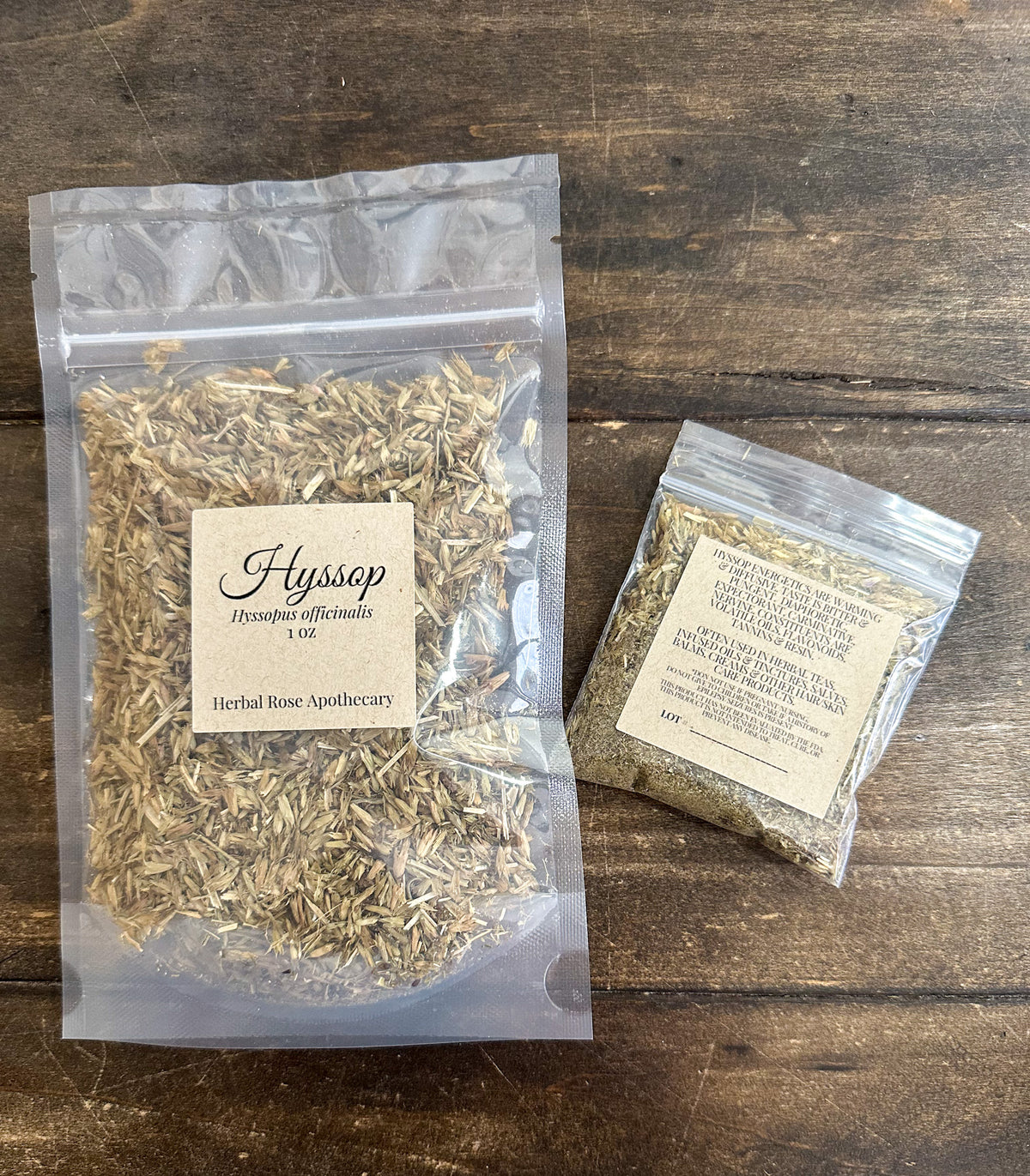 two packages of hyssop in clear packages on a wooden surface from herbal rose apothecary