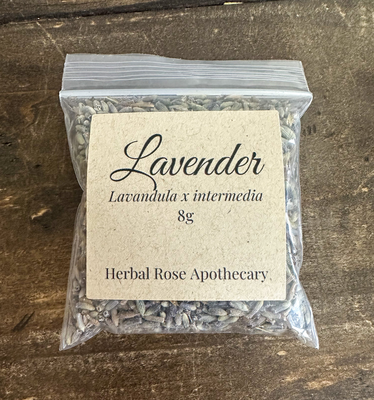 dried lavender buds in a clear 8g bag on a wooden surface