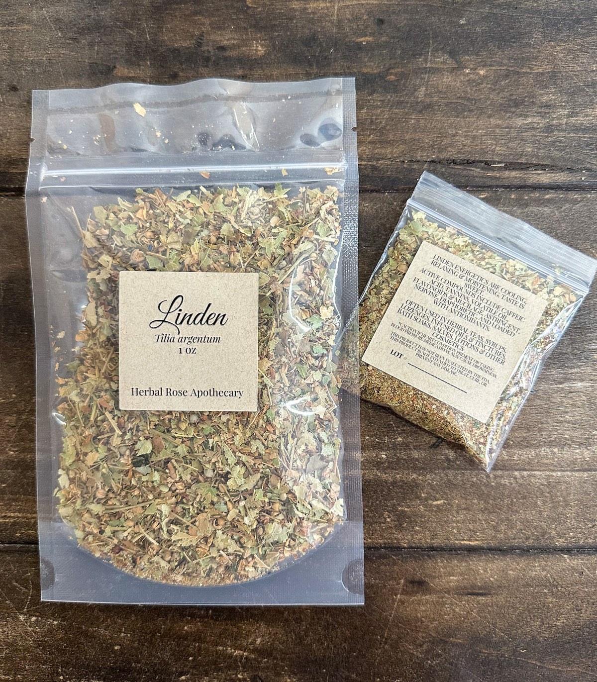 two packages of dried linden packaged in clear resealable bags laid on a wooden surface from herbal rose apothecary