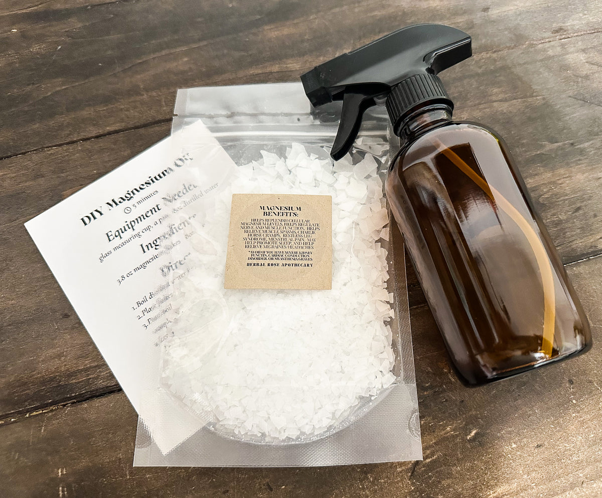 DIY magnesium oil spray kit laid out on a wooden surface 