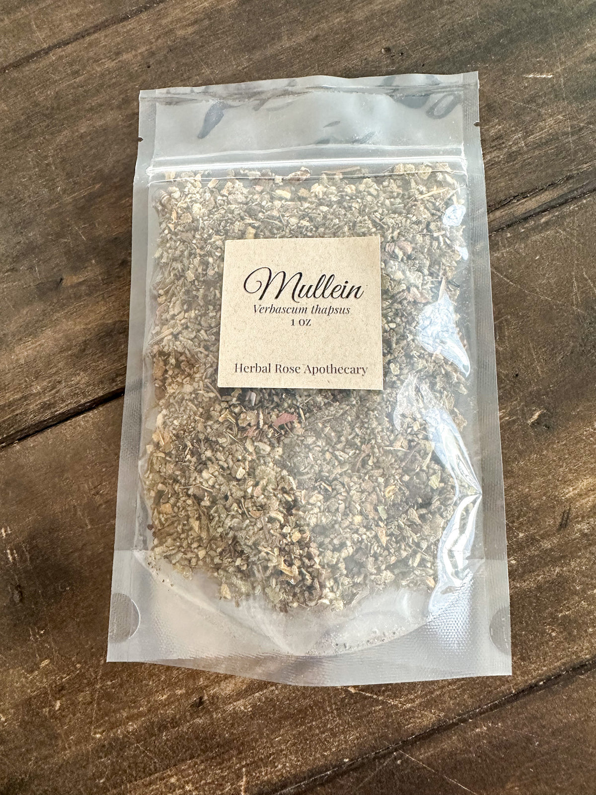 dried mullein leaf 1oz bag packaged into a clear resealable bag on a wooden surface