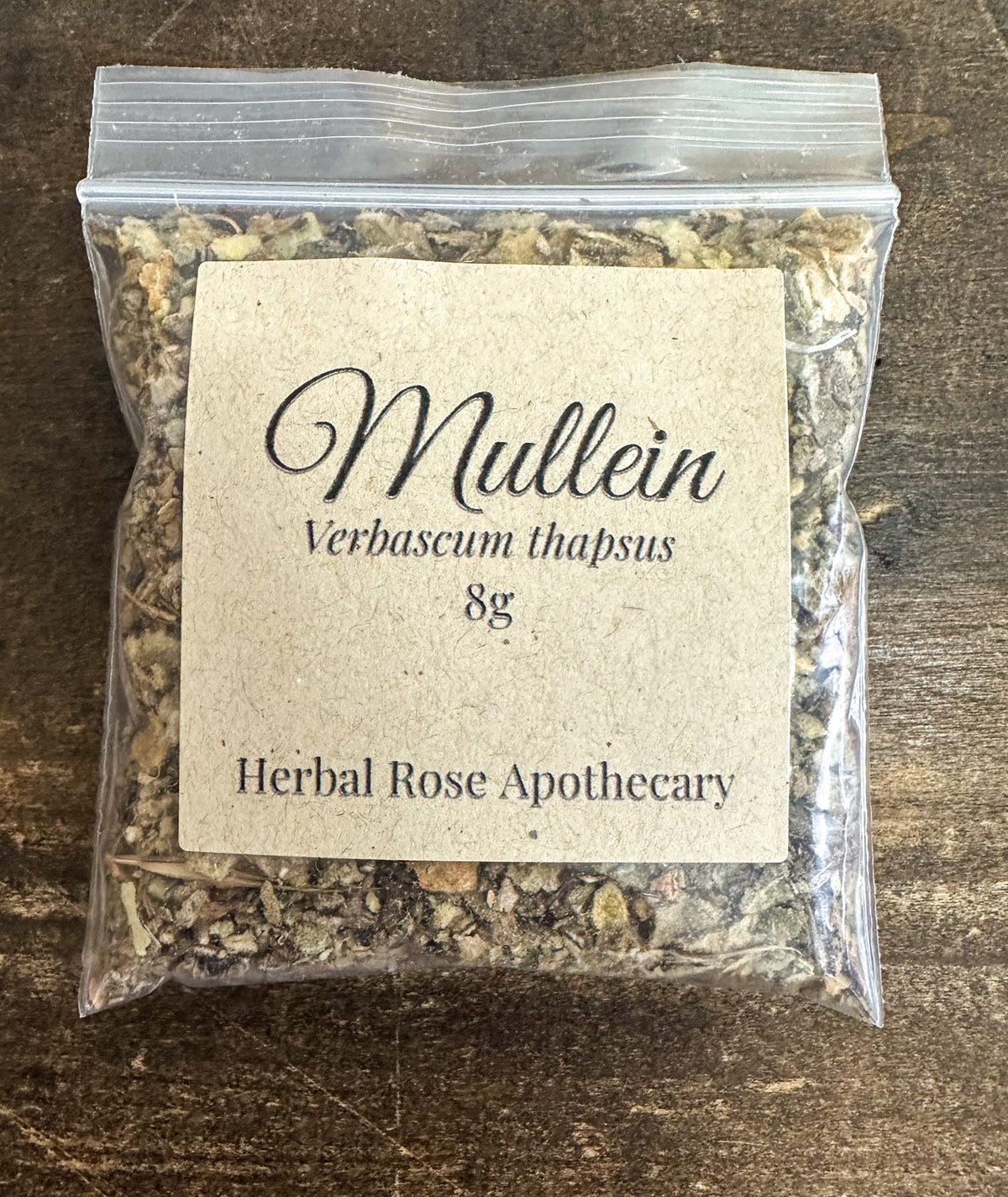 dried mullein leaf packaged into a clear resealable bag on a wooden surface