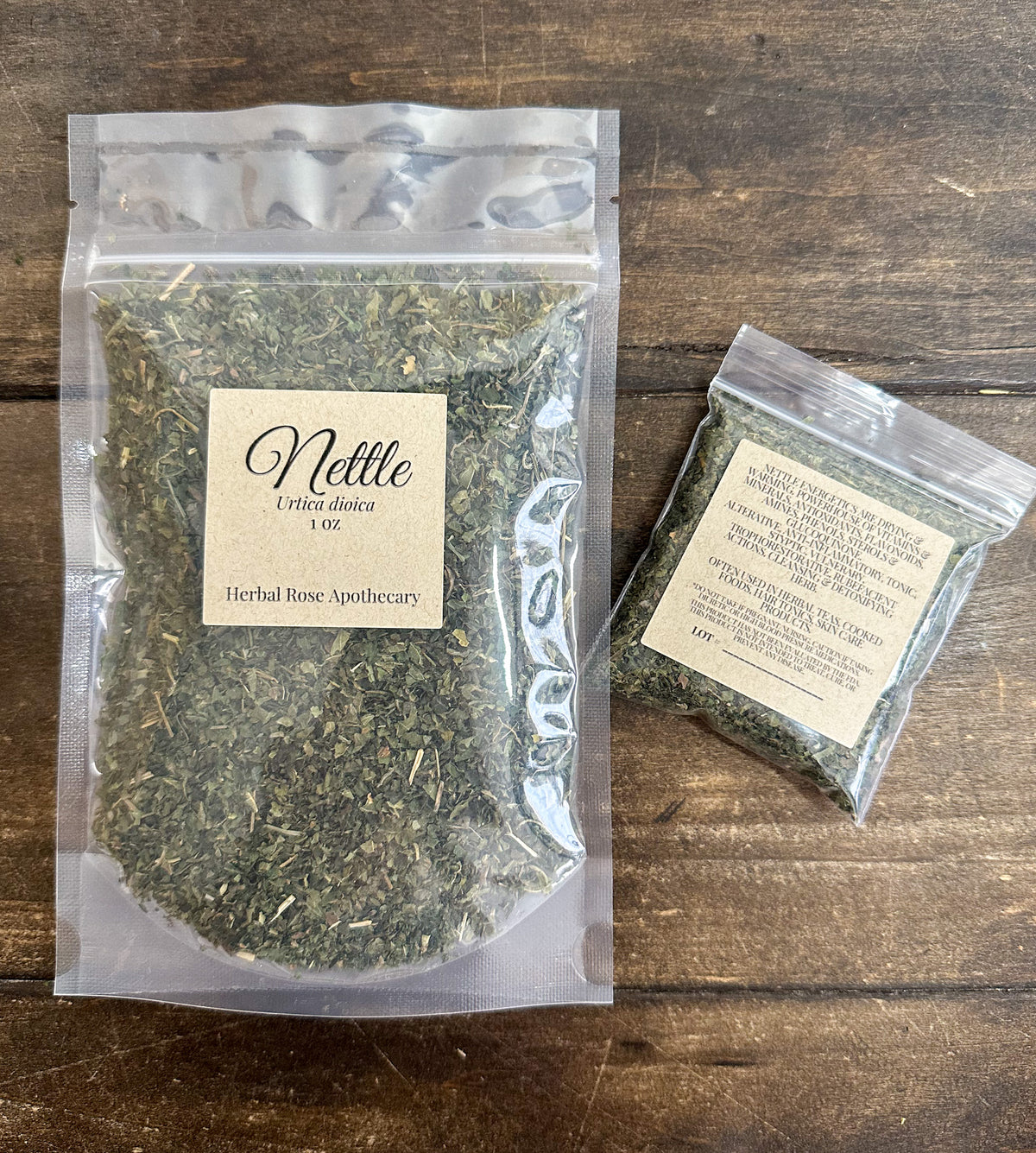 two packages of dried nettle packaged into clear resealable bags on wooden surface from herbal rose apothecary