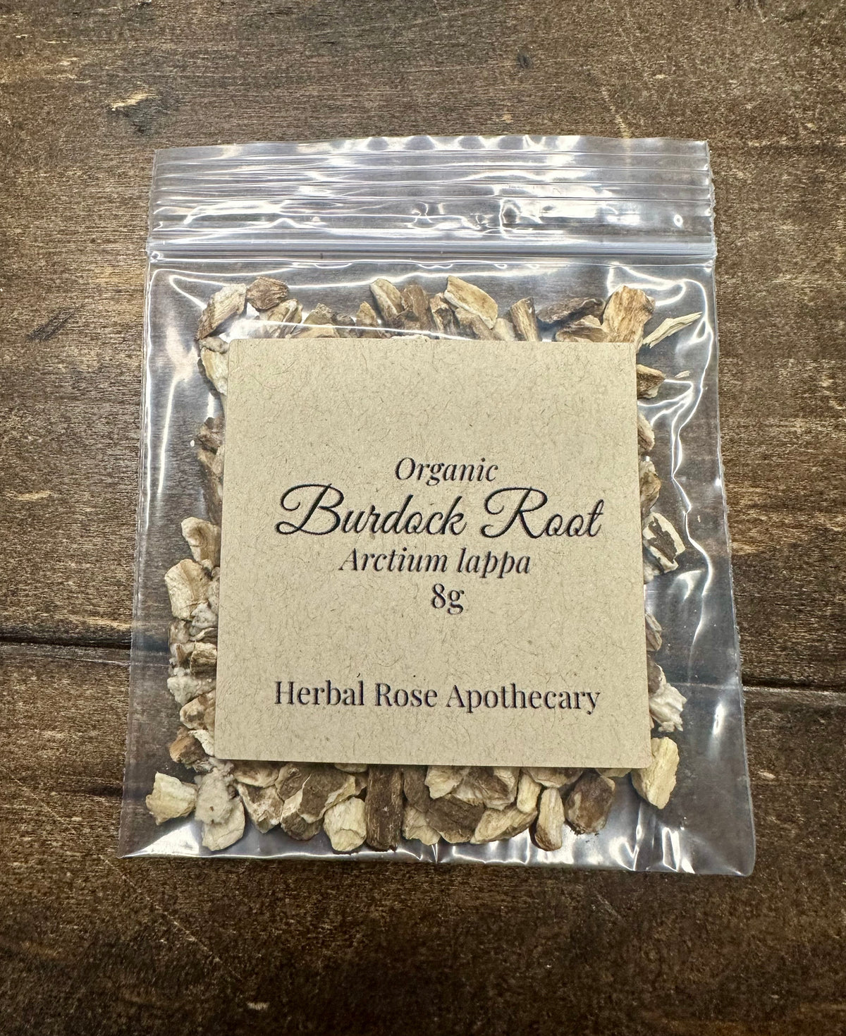dried organic burdock root 8g bag in clear resealable bag on wooden surface