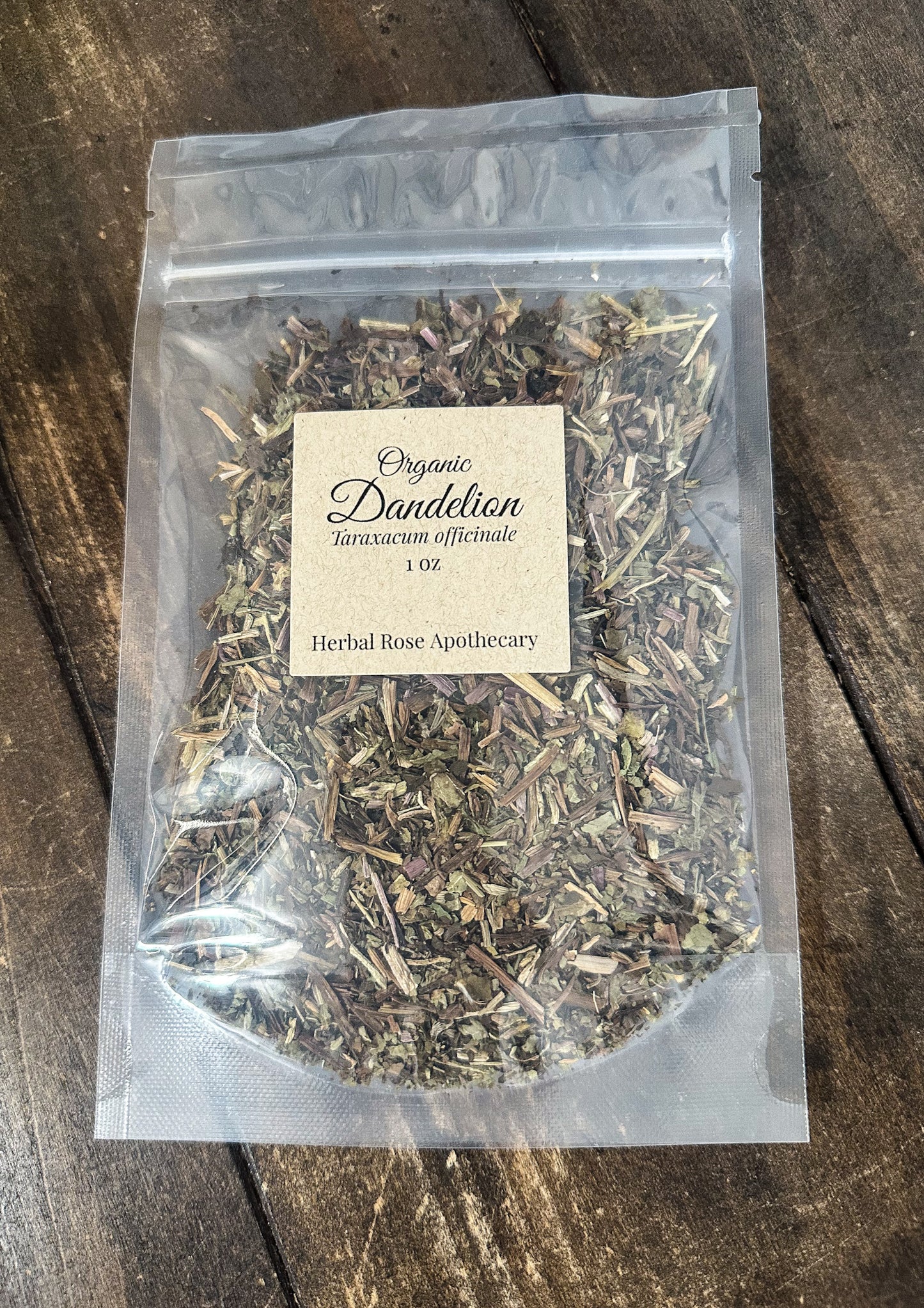 dried organic dandelion in a clear resealable 1oz bag on a wooden surface