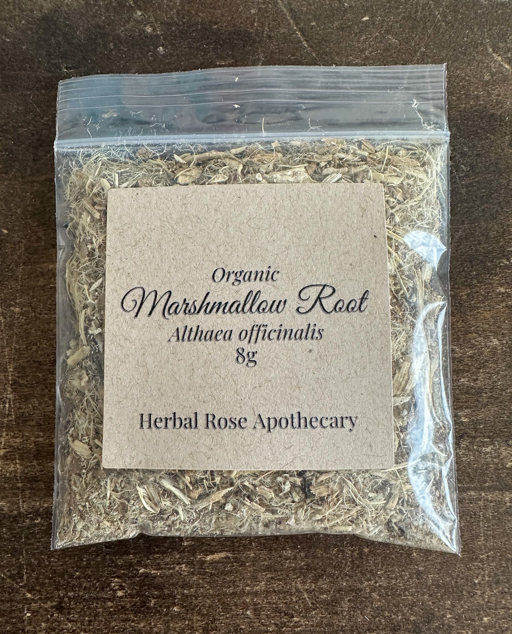 dried organic marshmallow root in 8g clear resealable bag on a wooden surface