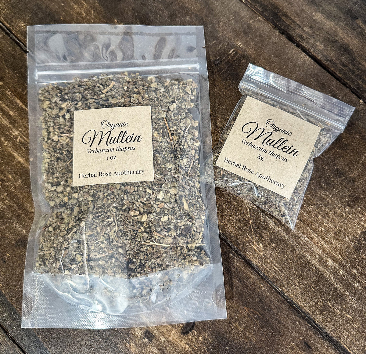 two packages of dried organic mullein in clear resealable bags from herbal rose apothecary on a wooden surface