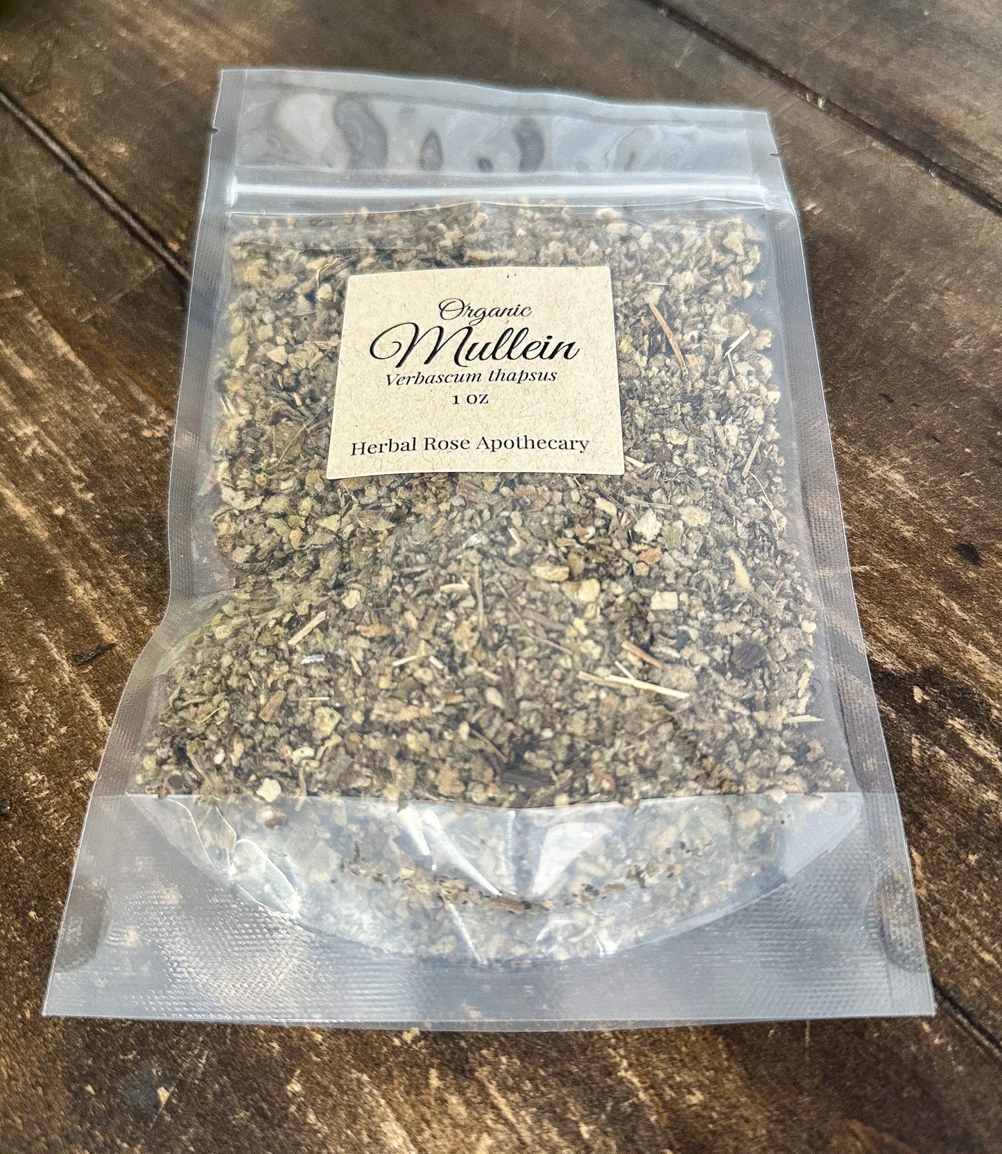 dried organic mullein leaves in a 1oz clear resealable bag on a wooden surface