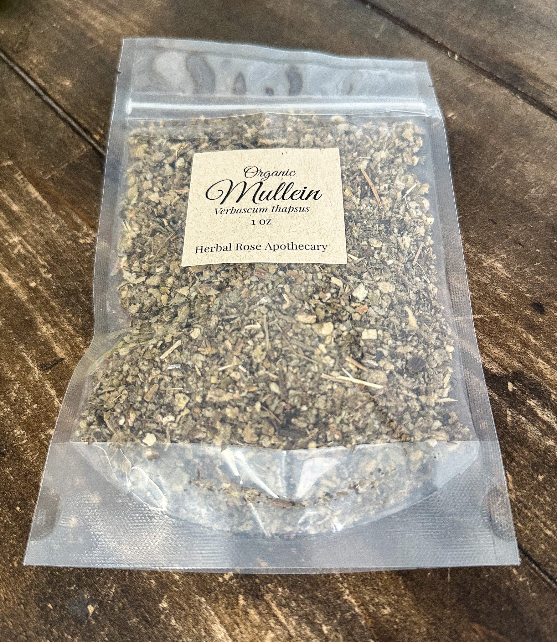dried organic mullein leaves in a 1oz clear resealable bag on a wooden surface