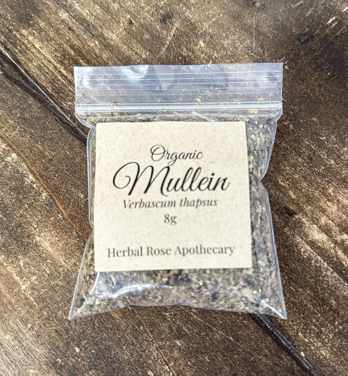 dried organic mullein leaves in a 8g clear resealable bag on a wooden surface