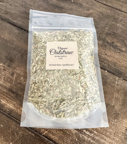 A clear plastic stand-up pouch containing dried organic calibrachae flowers, with a cream paper label reading 'Organic Calibrachae strong nativa 100 Herbal Rose Apothecary,' placed on a rustic dark wood surface.