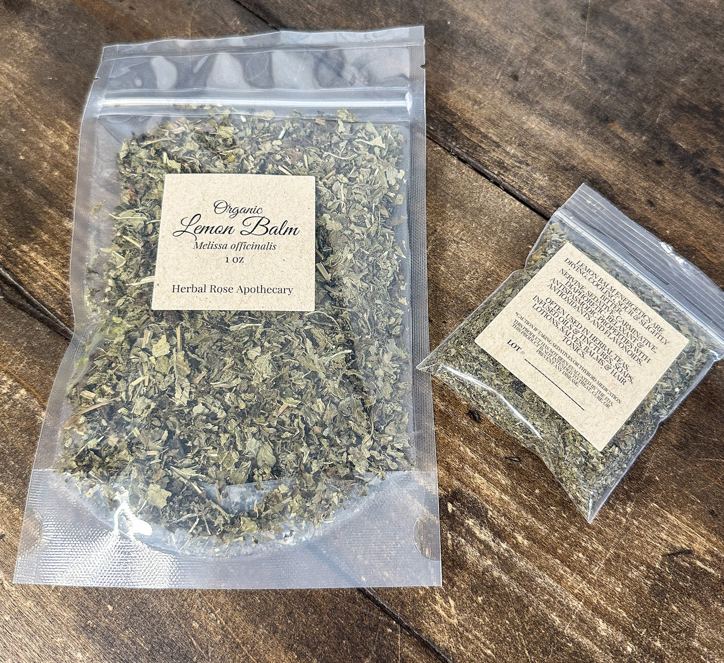 2 clear bags filled with dried organic lemon balm leaf on a wooden background