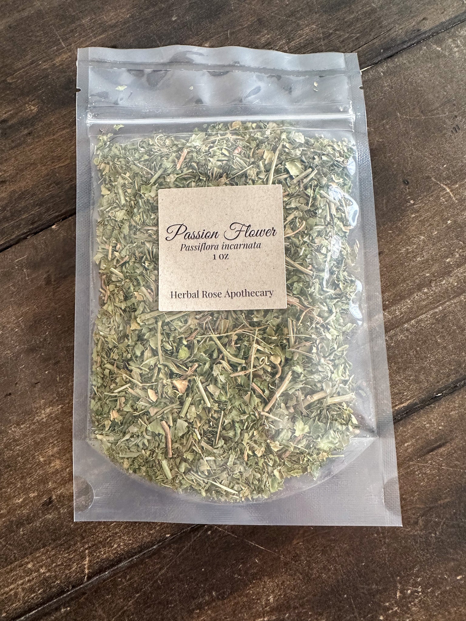 dried passion flower 1oz bag in clear resealable bag on wooden surface