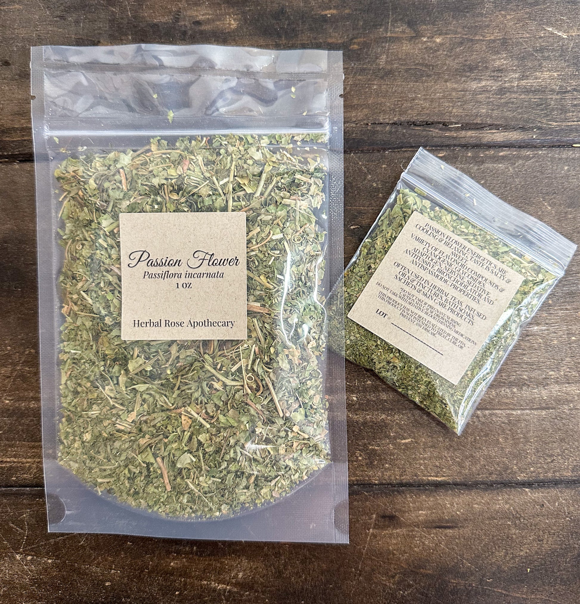 two packages of dried passion flower leaves in clear resealable bags from herbal rose apothecary on a wooden surface