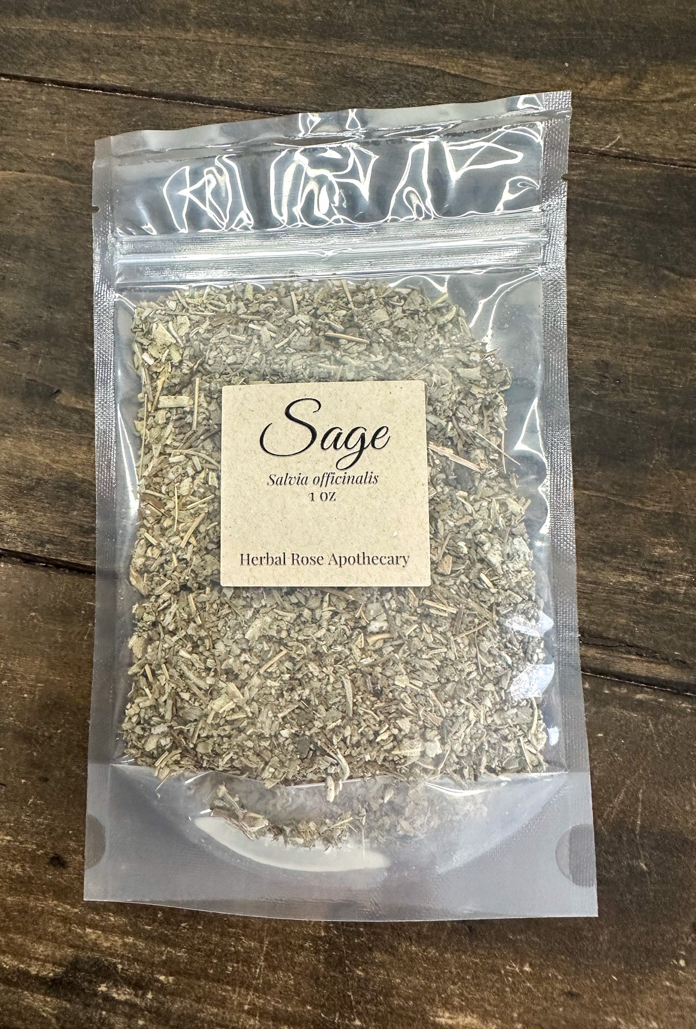 dried sage leaves in 1oz clear resealable bag on wooden surface
