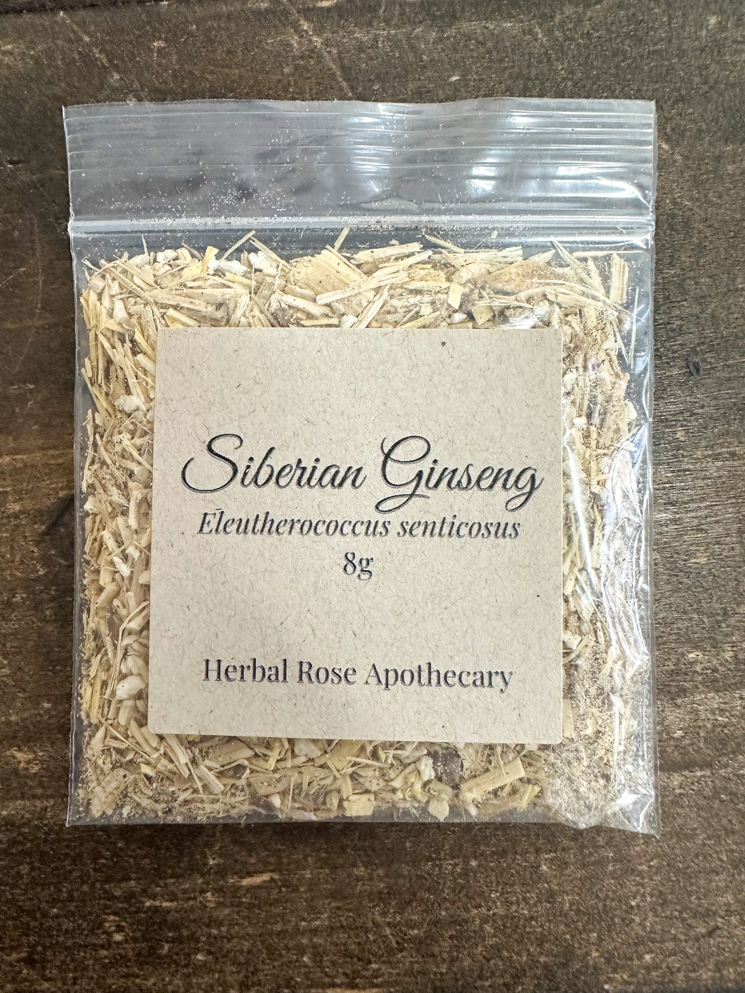 dried siberian ginseng in 8g clear resealable bag on wooden surface