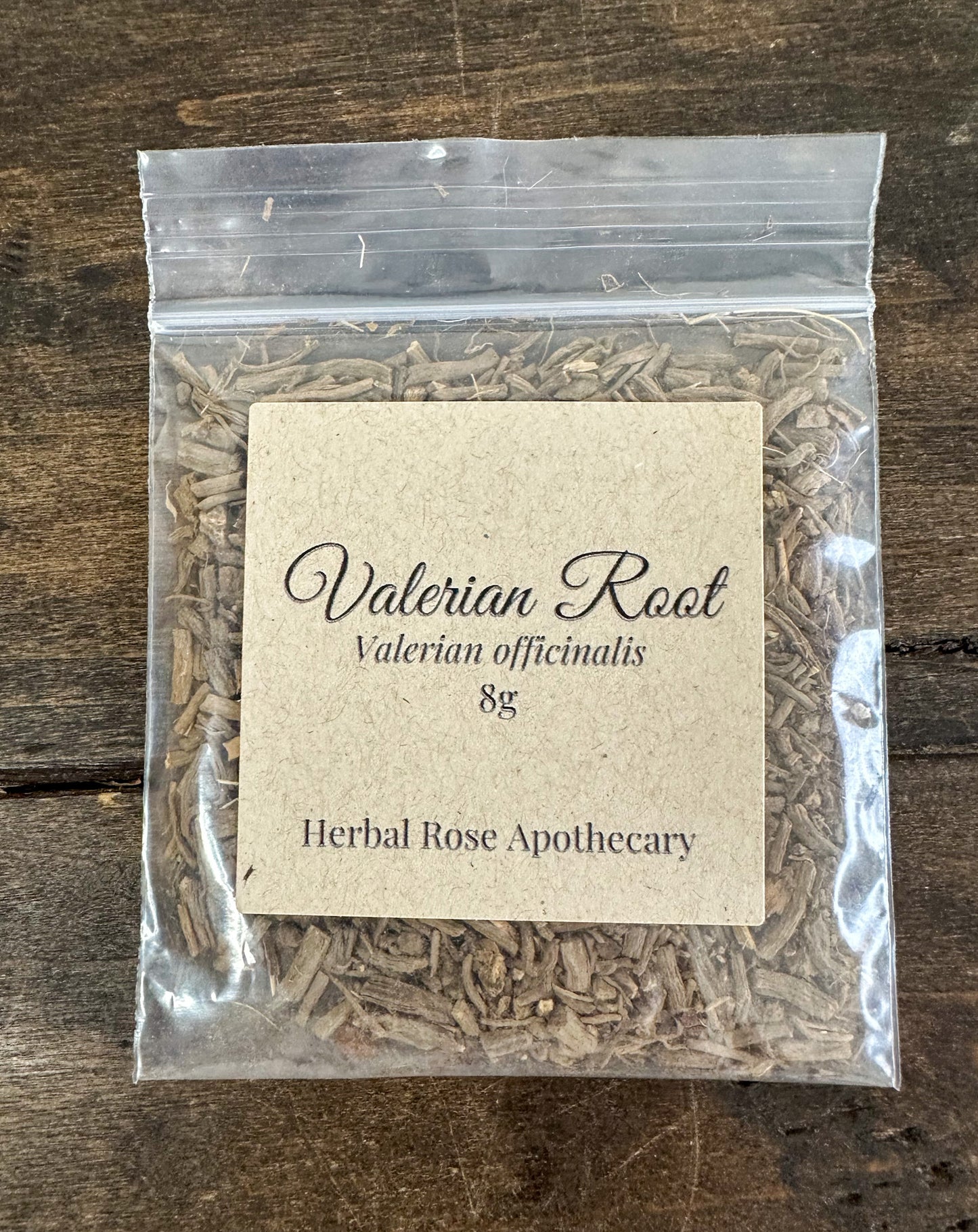 dried valerian root in 8g clear resealable bag on wooden surface