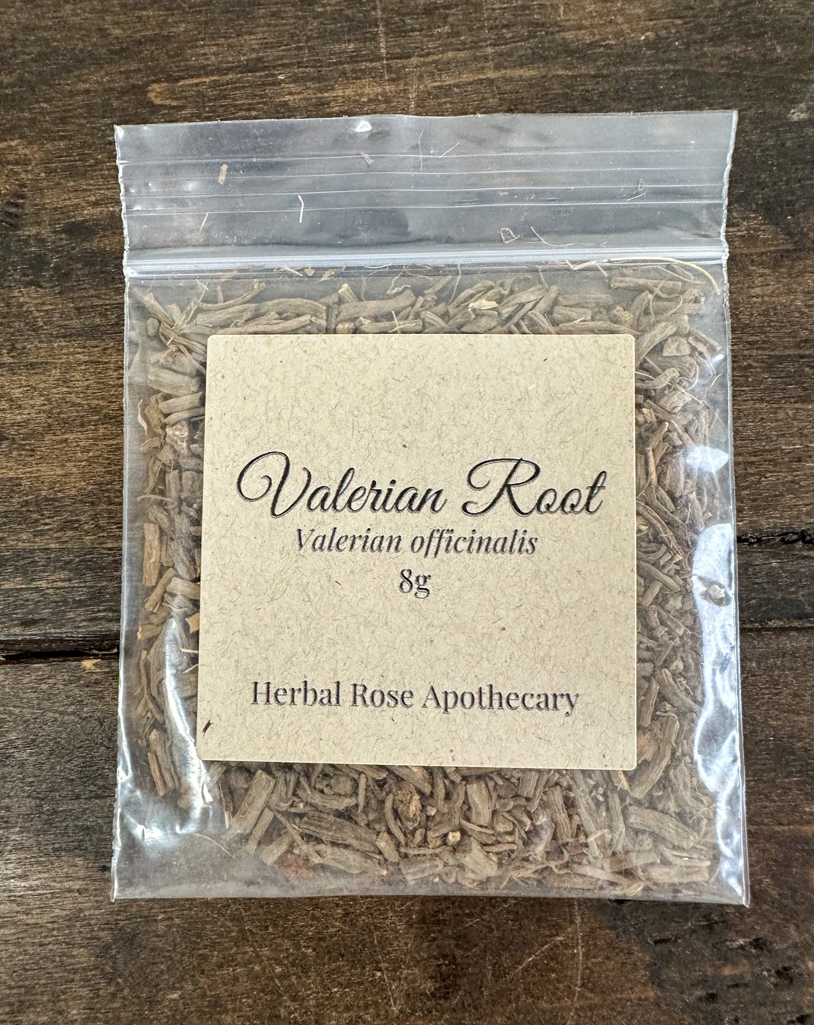 dried valerian root in 8g clear resealable bag on wooden surface