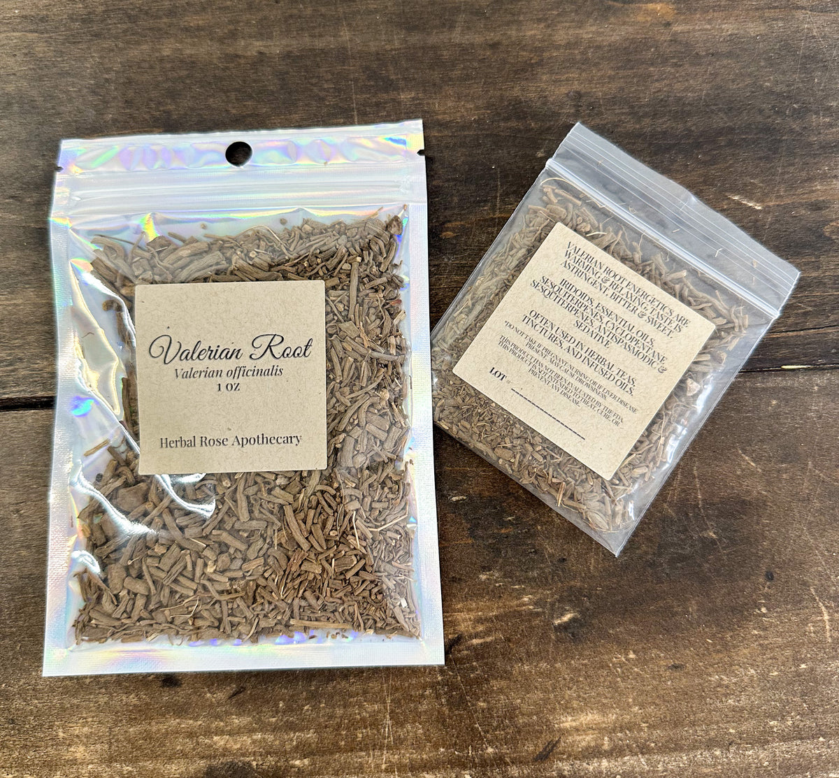 two packages of dried valerian root in clear resealable bags from herbal rose apothecary on a wooden surface
