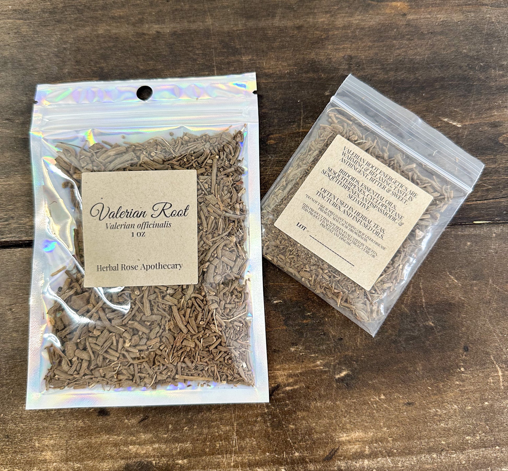two packages of dried valerian root in clear resealable bags from herbal rose apothecary on a wooden surface